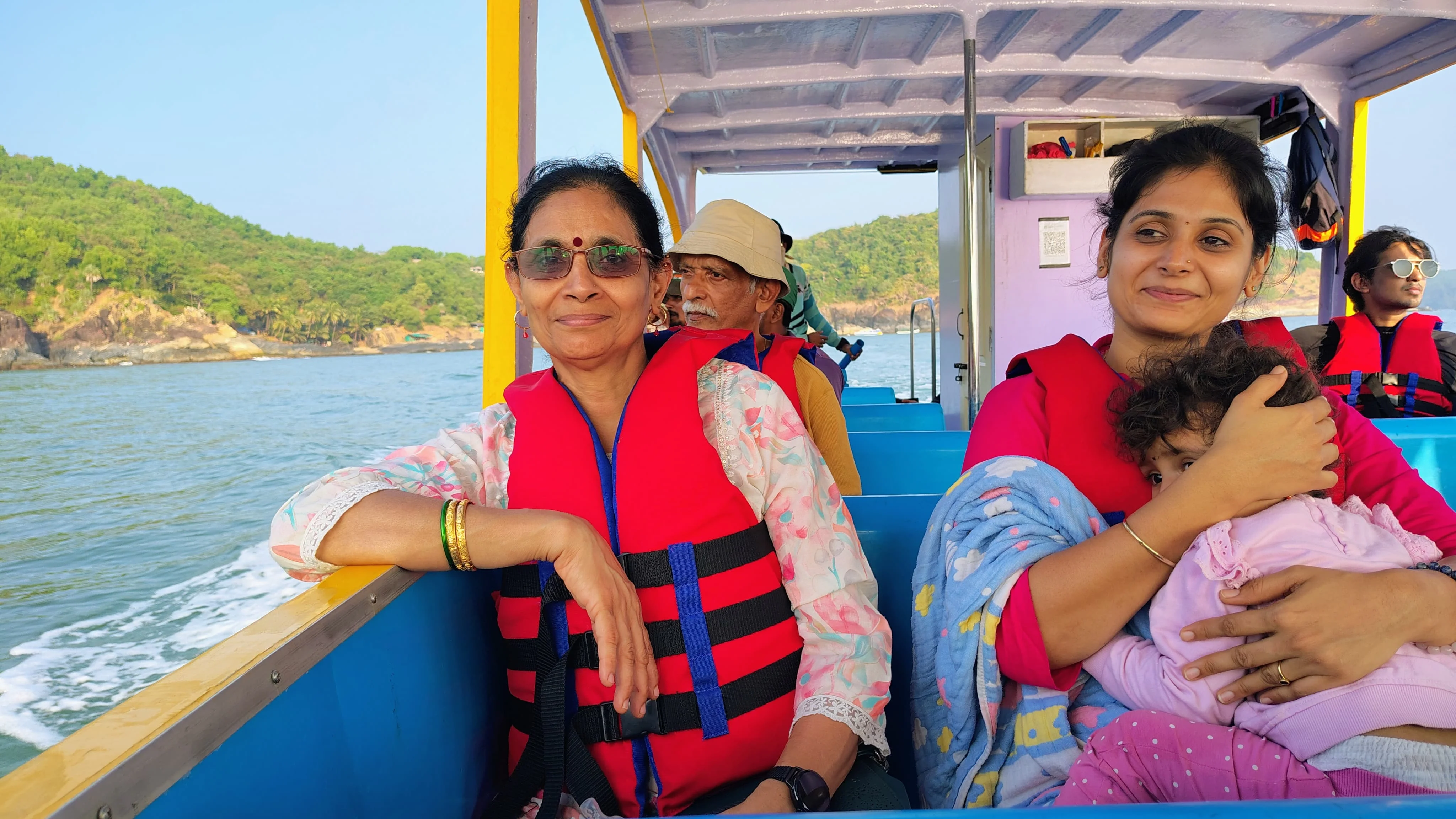 Family enjoying safe and fun boat ride experience Family enjoying boat ride in Gokarna sea adventure